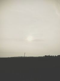 Silhouette of field against sky during sunset