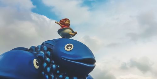 Low angle view of statue against cloudy sky