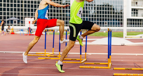 Low section of athletes running on sports track