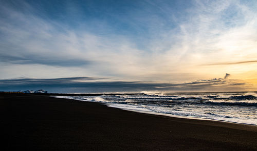 Scenic view of beach against sky during sunset