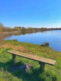 Scenic view of lake against clear blue sky