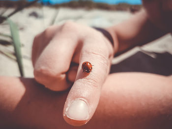 Close-up of hand holding cigarette