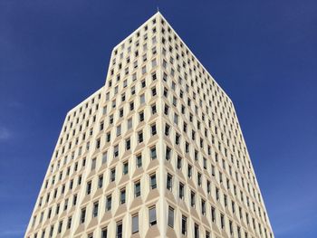 Low angle view of modern building against clear blue sky