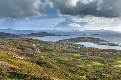 Scenic view of sea and mountains against sky