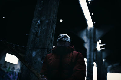 Low angle view of person standing at night