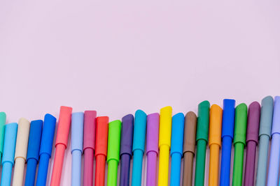 Close-up of multi colored pencils against white background