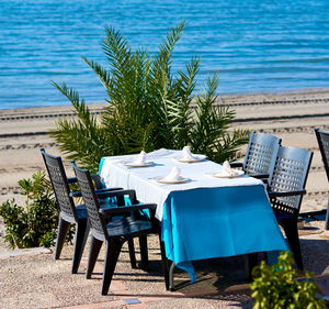 Chairs arranged by table at outdoor restaurant