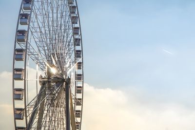 Minimal low angle view of big wheel attraction part against cloudy sky, paris, france.