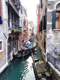 Boats moored on canal in city