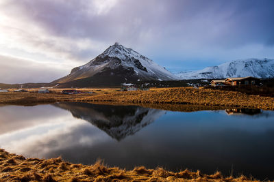 Icelandic dramatic landscape with lake and stapafell mountains covered in snow in iceland