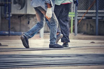 Low section of men working at construction site