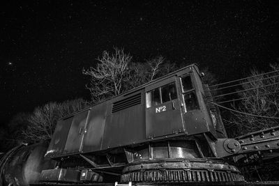 Low angle view of bare trees at night