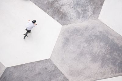 Directly above shot of person riding bmx cycling at skateboard park