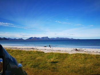 Scenic view of beach against blue sky