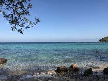 Scenic view of sea against clear blue sky