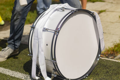 Drum on football. football fan beats drumsticks into membrane.