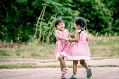 Twin sisters playing at public park