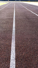 Running track in sports stadium. red running or jogging race track rubber with white textured lines.