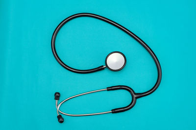 High angle view of eyeglasses on blue table