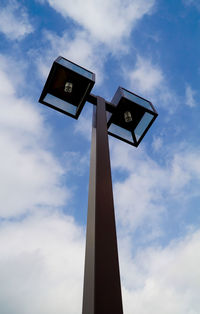 Low angle view of road sign against sky