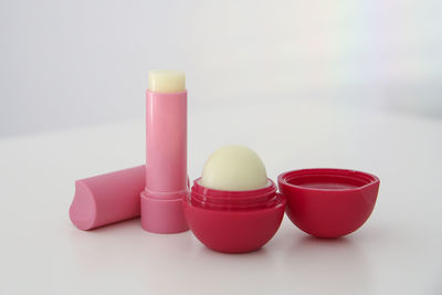 Close-up of multi colored beauty products against white background