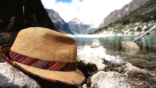 Scenic view of lake by rocks against mountains