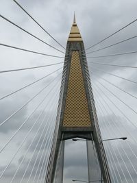 Low angle view of suspension bridge against sky