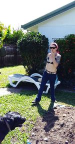 Full length of senior woman standing in lawn