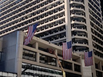 Low angle view of flag against buildings in city