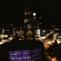 Illuminated buildings against sky at night