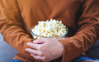 Midsection of woman holding food