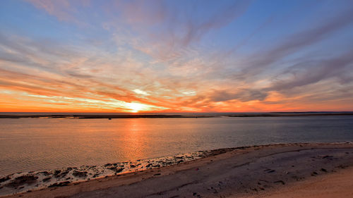 Scenic view of beach against sky during sunset