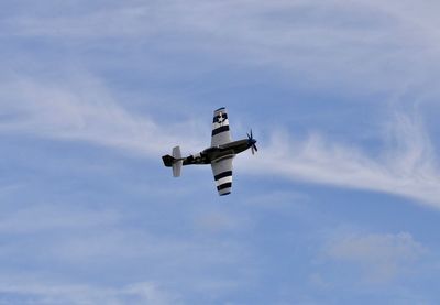 Low angle view of flying against sky