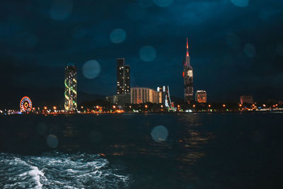 Illuminated buildings in city at night