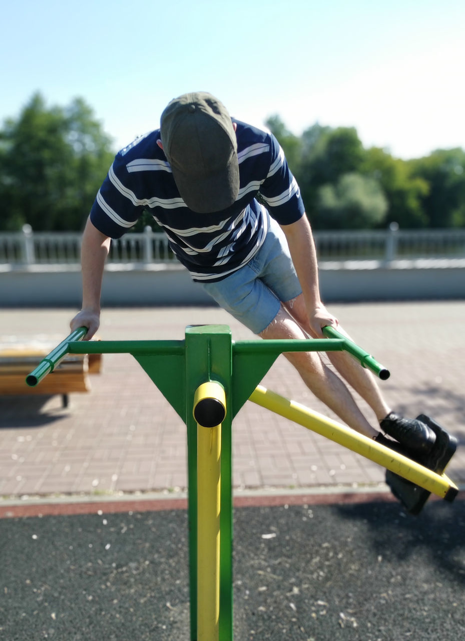 REAR VIEW OF BOY RIDING