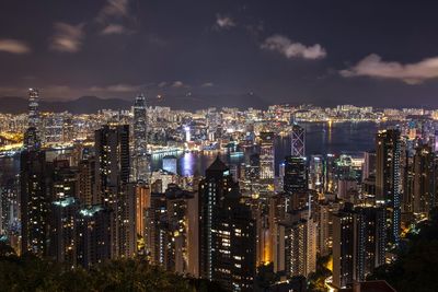 High angle view of illuminated cityscape against sky at night