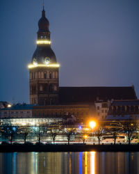 Illuminated buildings against sky at night