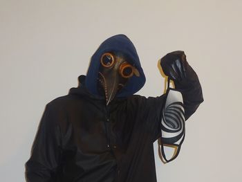 Man wearing mask against white background