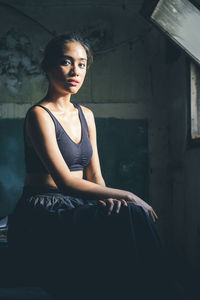 Portrait of young woman sitting outdoors