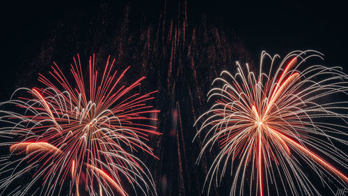 Low angle view of firework display at night