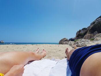 Low section of people relaxing at beach