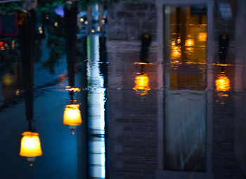 Illuminated street light in city at night