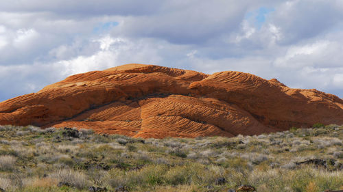 Rock formations on landscape against sky