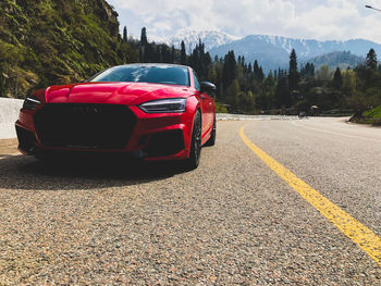 Car on road against sky in city