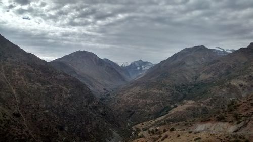 Scenic view of mountains against cloudy sky