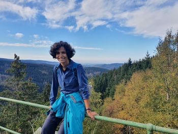 Woman standing against blue sky