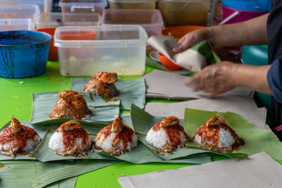 Close-up of person preparing food on table