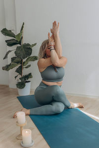 Full length of woman sitting on table