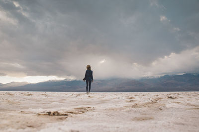 Full length of man standing on desert against sky