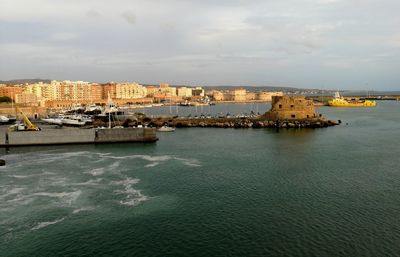 Scenic view of sea and buildings against sky